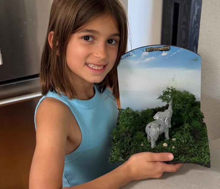 Child proudly showing Vigdee wildlife craft kit project