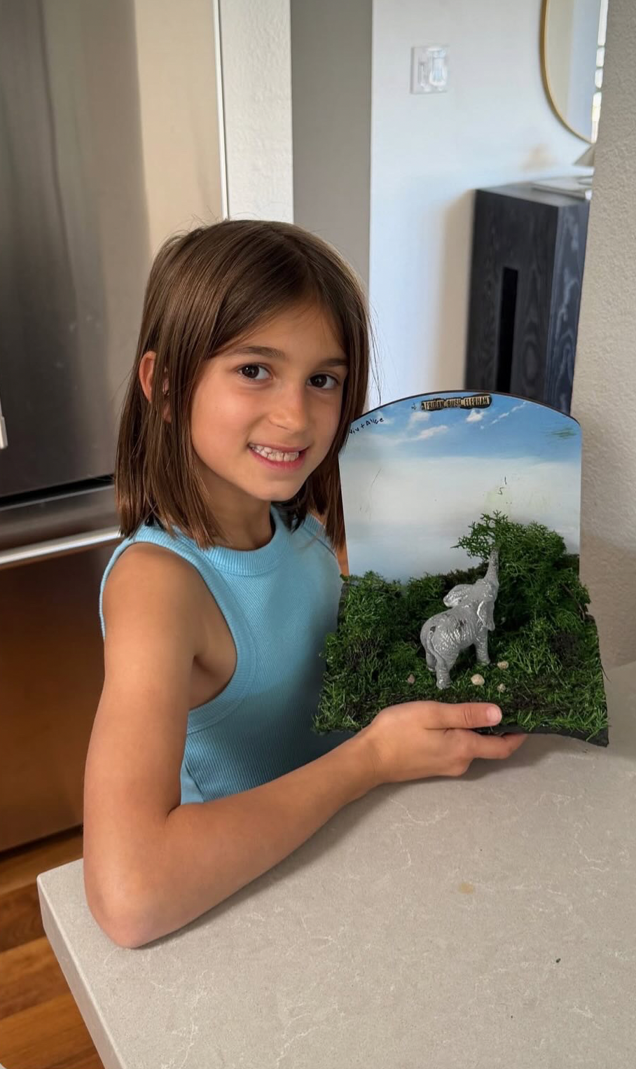 Child proudly showing Vigdee wildlife craft kit project